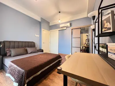 a bedroom with a bed and a table at Arte Mont Kiara by RKD HOME in Kuala Lumpur