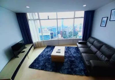 a living room with a couch and a large window at Vortex KLCC Area in Kuala Lumpur
