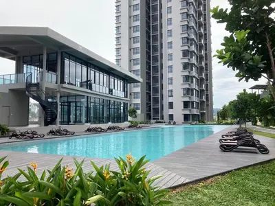 a large building with a swimming pool in front of a building at Astoria Ampang By Grabstay in Kuala Lumpur