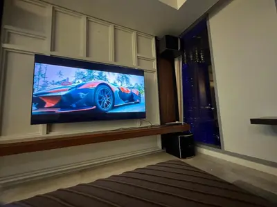 a room with a tv with a car on the screen at Tropicana The Residence By Klcc in Kuala Lumpur