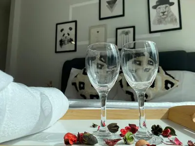 two wine glasses sitting on top of a table at Sky Suite KLCC Studio Suite in Kuala Lumpur