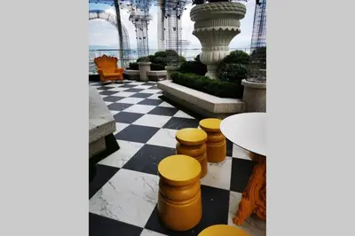 a room with a checkered floor and a table and chairs at HappyHome @ Arte Mont Kiara Kuala Lumpur Hartamas Damansara in Kuala Lumpur