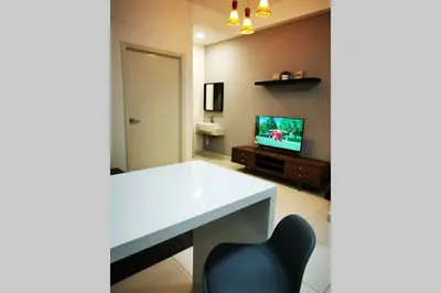 a room with a white table and a chair and a television at HappyHome @ Arte Mont Kiara Kuala Lumpur Hartamas Damansara in Kuala Lumpur