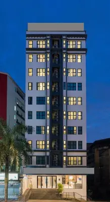 a tall building with lights on in a city at Ramada Encore by Wyndham Chinatown Kuala Lumpur in Kuala Lumpur