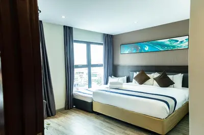 a bedroom with a large bed with a large window at Ramada Encore by Wyndham Chinatown Kuala Lumpur in Kuala Lumpur