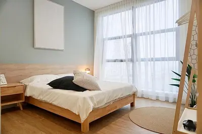 a bedroom with a bed and a large window at Arte Mont Kiara by CozyNest in Kuala Lumpur