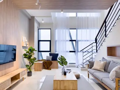 a living room with a couch and a tv at Arte Mont Kiara by CozyNest in Kuala Lumpur