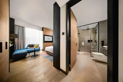 a room with a bathroom with a bed and a toilet at Capri by Fraser, Bukit Bintang in Kuala Lumpur