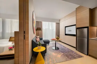 a hotel room with a table and a kitchen at Capri by Fraser, Bukit Bintang in Kuala Lumpur