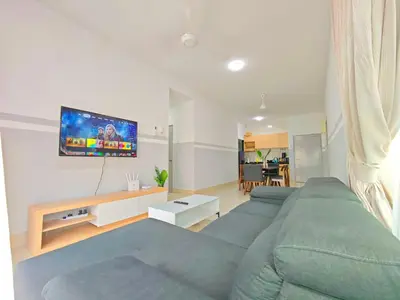a living room with a couch and a flat screen tv at Razak City Residence at Sungai Besi, Kuala Lumpur by Liberty Homes in Kuala Lumpur