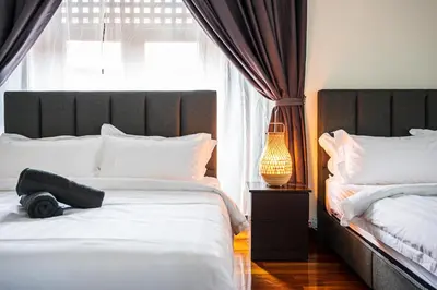 a bedroom with two beds and a lamp and a window at 6BR San He Yuan RIAD Private Pool Villa KLCC View by Verano in Kuala Lumpur