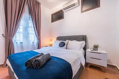 a bedroom with a large bed with towels on it at 6BR San He Yuan RIAD Private Pool Villa KLCC View by Verano in Kuala Lumpur