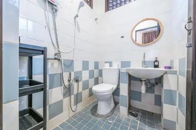 a bathroom with a toilet and a sink and a mirror at 6BR San He Yuan RIAD Private Pool Villa KLCC View by Verano in Kuala Lumpur
