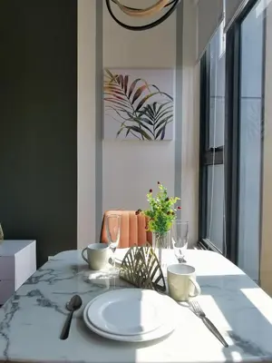 a dining room table with a white plate on it at Ceylonz Suites KL Studio near Bukit Bintang - Living Signature in Kuala Lumpur