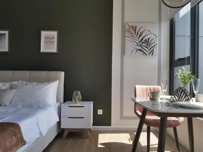 a bedroom with a bed and a table and a table and chair at Ceylonz Suites KL Studio near Bukit Bintang - Living Signature in Kuala Lumpur