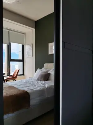 a bedroom with a bed and a chair and a window at Ceylonz Suites KL Studio near Bukit Bintang - Living Signature in Kuala Lumpur