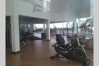 a gym with several treadmills and exercise bikes at Cozy designer loft near KL city center in Ampang
