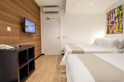 a hotel room with two beds and a flat screen tv at 12FLY Hotel Kuala Lumpur in Kuala Lumpur