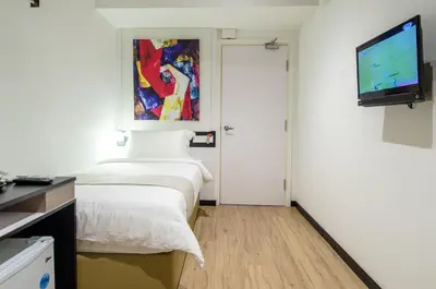 a hotel room with two beds and a flat screen tv at 12FLY Hotel Kuala Lumpur in Kuala Lumpur