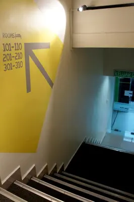 a set of stairs with a sign on the wall at Maple Inn in Kuala Lumpur