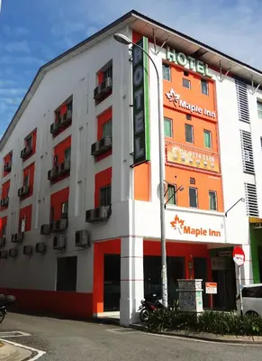 a hotel with a sign on the side of a building at Maple Inn in Kuala Lumpur