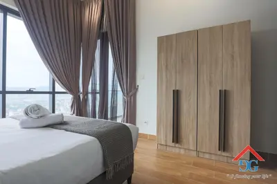 a bedroom with a large bed and a large window at The Elements by Grabstay in Kuala Lumpur