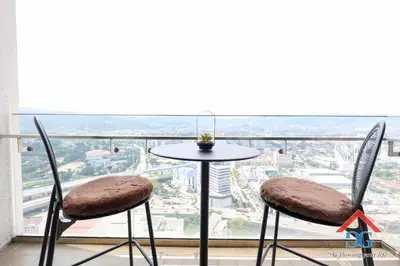 a table and two chairs in front of a window at The Elements by Grabstay in Kuala Lumpur