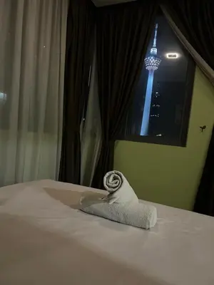 a bed with a towel on it with the eiffel tower at Mercu Summer Suites KLCC by SS Residence in Kuala Lumpur