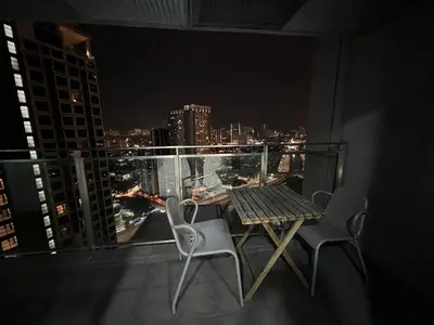 a table and chairs on a balcony with a city skyline at Mercu Summer Suites KLCC by SS Residence in Kuala Lumpur