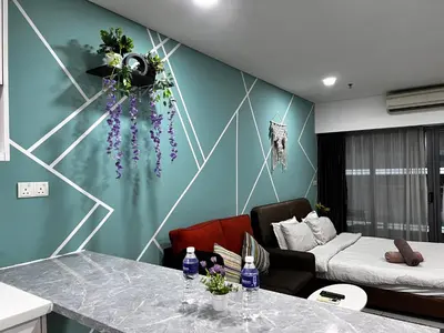 a living room with a couch and a table at Mercu Summer Suites KLCC by SS Residence in Kuala Lumpur
