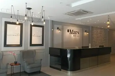 a waiting room with two chairs and a reception desk at Mars Hotel in Kuala Lumpur