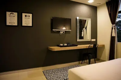 a bedroom with a desk and a mirror on the wall at Mars Hotel in Kuala Lumpur
