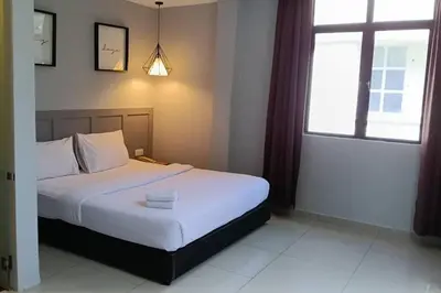 a bedroom with a bed and a window at Mars Hotel in Kuala Lumpur