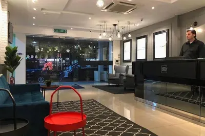 a man standing at the cash register of a store at Mars Hotel in Kuala Lumpur