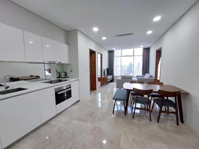 a kitchen and dining room with a table and chairs at Sky Suites with KLCC Twin Tower View by iRent365 in Kuala Lumpur