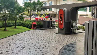 a red fire hydrant on a sidewalk in a city at Sky Suites with KLCC Twin Tower View by iRent365 in Kuala Lumpur