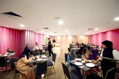 a group of people sitting at tables in a restaurant at Seeds Hotel Premier Pudu Kuala Lumpur Previously Hotel Pudu Plaza KL in Kuala Lumpur