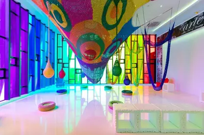 a room with a table and a colorful ceiling at Arte Mont Kiara Homestay in Kuala Lumpur