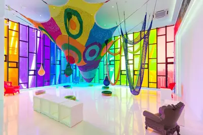 a room with a colorful wall of glass at Arte Mont Kiara Homestay in Kuala Lumpur