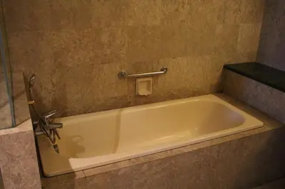 a bath tub in a bathroom with a sink at Fantazya Suites Times Square in Kuala Lumpur