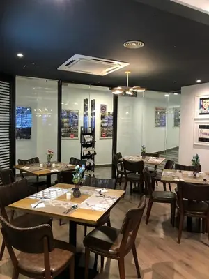a dining room with wooden tables and chairs at Alamis City Kuala Lumpur - Formerly EDC Hotel Kuala Lumpur in Kuala Lumpur