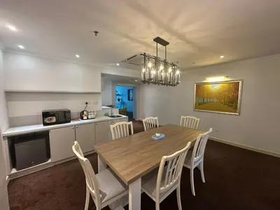 a kitchen and dining room with a wooden table and chairs at Alamis City Kuala Lumpur - Formerly EDC Hotel Kuala Lumpur in Kuala Lumpur
