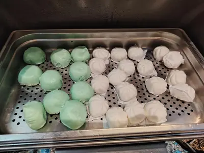 a metal tray filled with green and white donuts at Alamis City Kuala Lumpur - Formerly EDC Hotel Kuala Lumpur in Kuala Lumpur