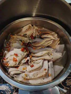 a pot full of chicken breasts with seasoning in it at Alamis City Kuala Lumpur - Formerly EDC Hotel Kuala Lumpur in Kuala Lumpur