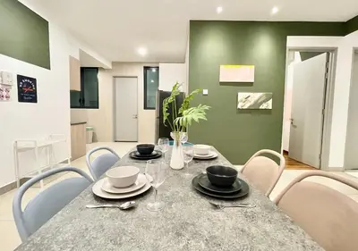a dining room with a table and chairs at KL Gateway Premium Residences by Moka in Kuala Lumpur