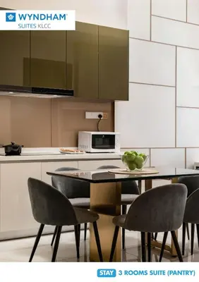 a kitchen with a table and chairs and a microwave at Wyndham Suites KLCC in Kuala Lumpur