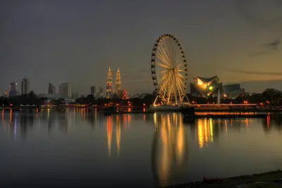 a ferris wheel sitting in the middle of a body of water at Titiwangsa Cabin Retreats by Vale Pine in Kuala Lumpur