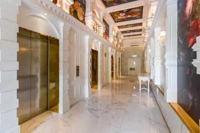 a hallway in a building with a table and a ceiling at Arte Mont Kiara by Airhost in Kuala Lumpur