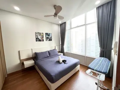 a bedroom with a bed with a teddy bear on it at Sky Suites KLCC by GENESIS in Kuala Lumpur