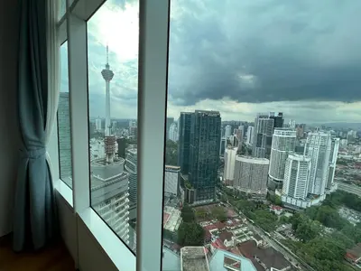 a view of a city skyline from a window at Sky Suites KLCC by GENESIS in Kuala Lumpur